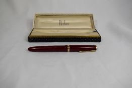 A boxed Parker Duofold Maxima aeromatic fill fountain pen in red, having broad decorative band to