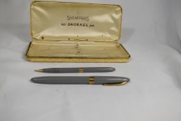 A boxed Sheaffer Snorkel fountain pen and propelling pencil set in grey having Sheaffer 14k nib.