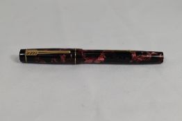 A Croxley 'The Croxley Pen' lever fill fountain pen in rose marble with single band to cap having