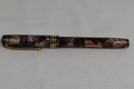 A Conway Stewart 388 lever fill fountain pen in rose marble with single broad band and two narrow