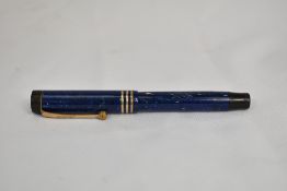 A Parker Duofold Deluxe Jr Lucky Curve button fill fountain pen in lapis blue with three bands to