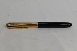 A De la Rue Onoto K1 plunger fill fountain pen in black with gold cap. Approx 13.2cm