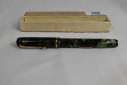A boxed Conway Stewart 286 lever fill fountain pen in green marble with single band to the cap