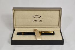 A boxed Parker Duofold Centenial Tester Mini converter fountain pen in black with one broad and
