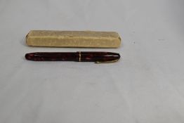 A boxed Conway Stewart 15 lever fill fountain pen in red black marble with single band to the cap