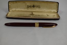 A Sheaffer Statesman Snorkel fountain pen in burgundy with broad band to the cap and white spot