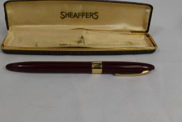 A Sheaffer Statesman Snorkel fountain pen in burgundy with broad band to the cap and white spot