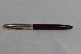 A Sheaffer Sentinel TM snorkel fountain pen in burgundy having steel cap with gold trim and white