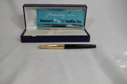 A boxed Waterman Converter Fill fountain pen in black with with rolled gold cap having 14ct nib.
