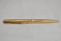 A Parker 65 ballpoint pen in gold fill. Slight ding to barrel