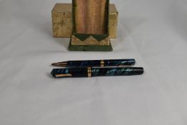 A boxed Eversharp bladder fill fountain pen and propelling pencil set in black and blue swirl with