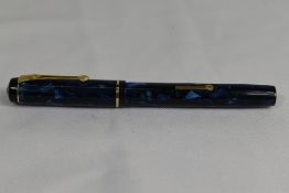 A Conway Stewart 476 lever fill fountain pen in blue black marble with a narrow bands to the cap