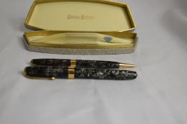 A boxed Conway Stewart 27 lever fill fountain pen and propelling pencil set in silver grey hatch