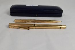 A boxed Mabie Todd Swan twist fill fountain pen and Fyne Poynt propelling pencil set in gold