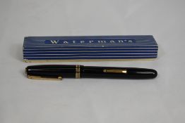 A boxed Waterman 513 lever fill fountain pen in black with three bands to the cap having Waterman