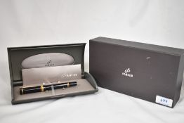 A boxed Parker International converter fill fountain pen in black with one broad and one narrow band