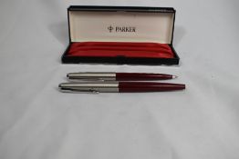 A Parker 45 fountain pen and ballpoint pen set in red in original box