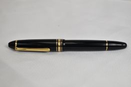 A Montblanc Meisterstuck 146 piston fill fountain pen in black with one broad and two narrow gold