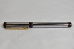 A Waterman Forum Converter fill fountain pen in stainless steel with red and gold trim having