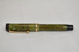 A Parker Duofold Jr Lucky Curve button fill fountain pen in Sage green with single band to Flat