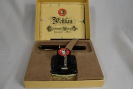 A Pelikan Gunther Wagner piston fill fountain pen in black with gold trim. Boxed with bottle of