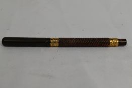 An Eyedropper fountain pen in red black ripple with twist pattern and broad gold bands to top and