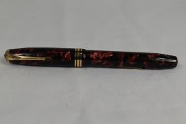 A Conway Stewart 58 lever fill fountain pen in red black marble with single broad band and two