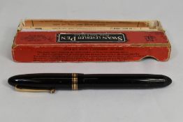 A boxed Mabie Todd Swan 4460 twist fill fountain pen in black with a broad and two narrow bands to