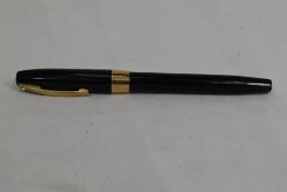 A Sheaffer Imperial Touchdown plunger fill fountain pen in black having broad band to cap and