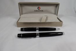 A boxed Sheaffer 300 converter fountain pen and ballpoint pen set in black having Sheaffer nib. In
