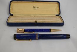 A boxed Parker Duofold button fill fountain pen and propelling pencil set in lapiz blue with two