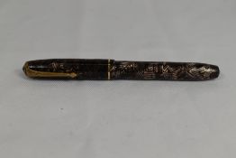 A Conway Stewart Relief 12 lever fill fountain pen in pink grey hatch with single band to the cap