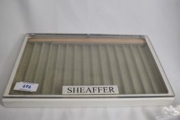 A hard pen display case marked Sheaffer
