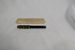 A Conway Stewart Dinkie 560 lever fill fountain pen in blue marble with gold veining having single