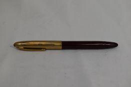 A Sheaffer Touchdown plunger fill fountain pen in red with gold cap having Sheaffer 14ct nib. Approx