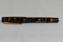 A Croxley 'The Croxley Pen' lever fill fountain pen in gold marble with single band to cap having