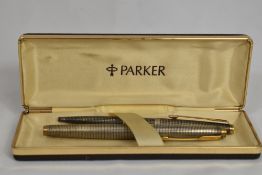 A boxed Parker 75 Cicele aerofill fountain pen and propelling pencil in sterling silver. In