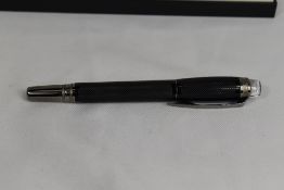 A Monteblanc FL Starwalker rollerball in black. As new in original box with service book and