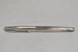 A Parker 75 cartridge converter fountain pen in silver plate with vertical lined pattern. In