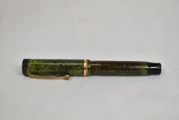 A Parker Duofold Jr Lucky Curve button fill fountain pen in Jade green with single band to Flat