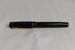 A Croxley lever fill fountain pen in black with single narrow band to cap having Dickenson nib.