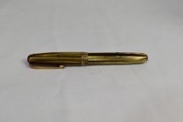 A Waterman 512V leverfill fountain pen in brown and yellow with two narrow bands to the cap having