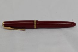 A Parker Duofold aeromatic fill fountain pen in red, having decorative broad band to the cap