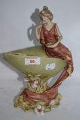 A Royal Dux figurine depicting classically dressed lady on shell, with foliage surrounding, 820