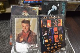 A collection of collectable calendars, including 1980s and 90s band interest such as Dire Straits,