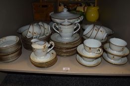 A partial dinner service having gilt accents to white ground,to be included are cups, saucers,
