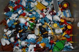 A box of collectable Smurf characters and a handful of vintage Wade whimsies.