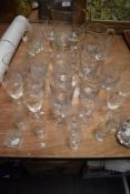 A mixed lot of glass, including vintage etched wine glasses and tumblers.