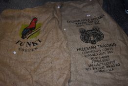 Two Hessian coffee sacks with printed details and designs.