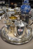 A selection of plated ware, including candlesticks, tray, jugs and more.